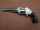 a close up of a revolver on a brown background