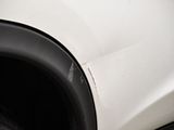 a close up of a white car with a black rim