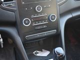 the interior of a car with a steering control and dashboard controls