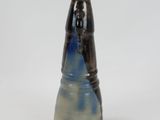 a blue and white vase sitting on a white surface