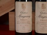 two bottles of wine sitting next to each other on a table