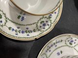three cups and a saucer on a table