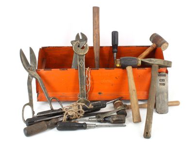 many different tools in a wooden box on a white surface
