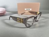 glasses with a box of donuts on a table next to a pair of eyeglasses