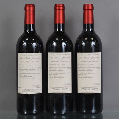 trois bouteilles de vin rouge sont alignées sur une table