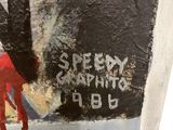 graffiti on the wall of a bathroom with a red paint dripping down the wall