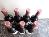 several bottles of wine are lined up on a counter top
