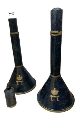 two black candlesticks that are sitting next to each other