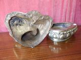 a silver heart shaped bowl and a silver heart shaped bowl on a wooden table