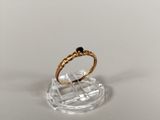 an image of a gold ring with a black stone on it