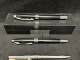 three different types of pens and a box on a table