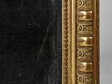 an image of a gold framed mirror with a black background
