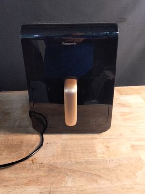 a black and gold water dispenser on a wooden table