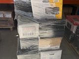 a large stack of boxes and pallets in a warehouse