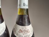 two bottles of wine sitting next to each other on a table