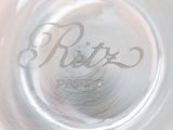 a close up of a silver plate with the word ritz on it