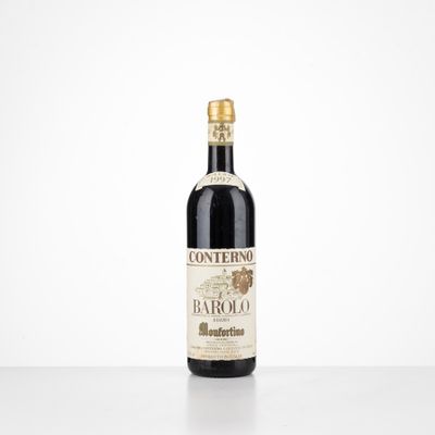 a bottle of wine sitting on top of a white table