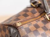 a close up of a brown and black handbag on a table