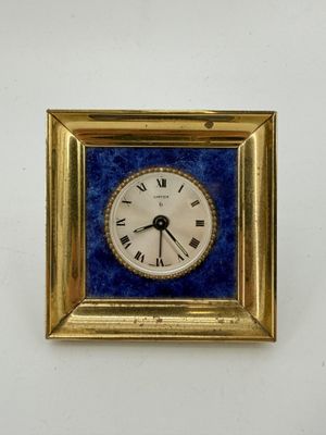 a gold frame with a blue and white clock on it