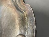 a close up of a metal object with a button on it