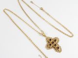 a gold plated necklace with a lion head pendant and a chain