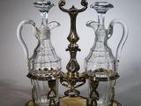 three glass vases sitting on top of a metal stand