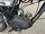 a close up of a motorcycle engine on the ground