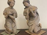 two statues that are sitting on a wooden table