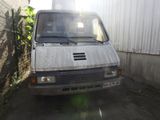 a van that is parked next to a fence