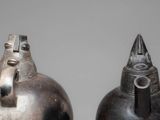 two vases that are sitting side by side on a table