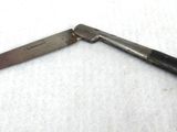 a small knife that is laying on a white surface