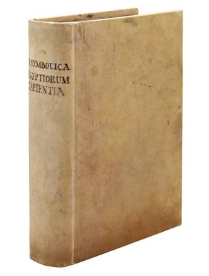 an old book sitting on top of a white surface