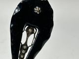 a close up of a black object on a white surface