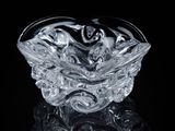 a glass bowl that is sitting on a black surface