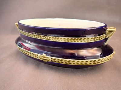 a purple and gold plate with a spoon on top of it