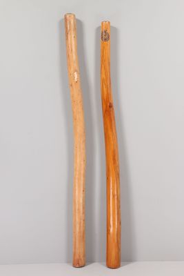 pair of wooden baseball bats sitting on top of a white table