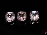 three square cut pink sapphires on a black background