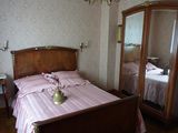 a bed with a pink comforter in a bedroom