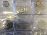 many different types of coins in a plastic box