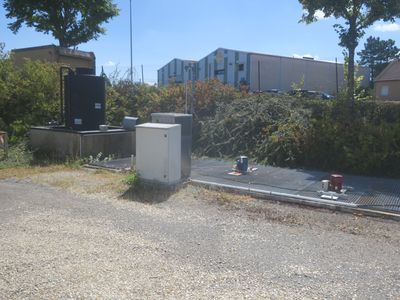 a white refrigerator sitting on the side of the road