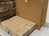 a stack of cardboard sitting on a table next to a stack of boxes