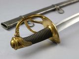 a sword with a gold handle and a ring on it