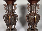 two vases that are sitting side by side on a table