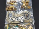 a close up of a bag of assorted jewelry on a table