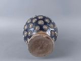 a close up of a silver and blue bead on a table
