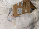a teddy bear that is wrapped in plastic and sitting in a bag