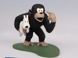 figurine of a monkey holding a rabbit in its hand