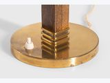the base of a brass plate with a wooden base and a white bead