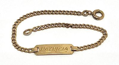 an image of a gold chain bracelet with a nameplate on it