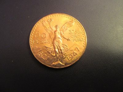 a gold coin that is on a black surface